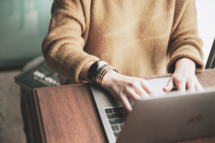 Detail shot typing on a laptop