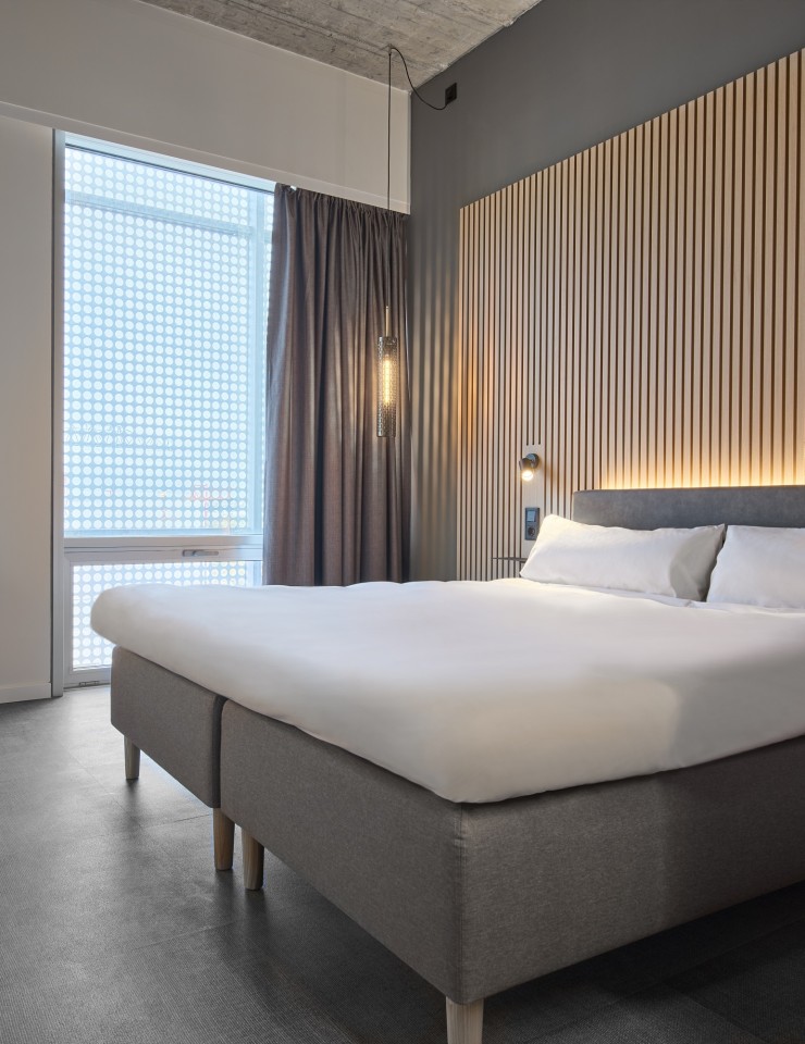 A Zleep Hotel sign on the facade of an historic building.