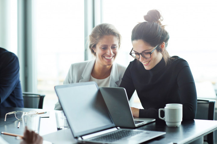Two woman looking on a laptop
